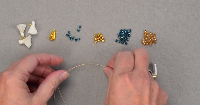 Attach a bead bug to one end of the wire to prevent beads from sliding off.