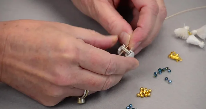 Attach a bead bug to one end of the wire to prevent beads from sliding off.