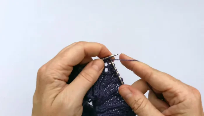 Round three: Begin with a purl stitch, knit the first two stitches, yarn over, and then perform a slip slip knit decrease (slip first stitch knitwise, slip second stitch purlwise, knit both through the back loop). Then, continue with the lace pattern (purl, knit two, yarn over, slip slip knit decrease, purl).