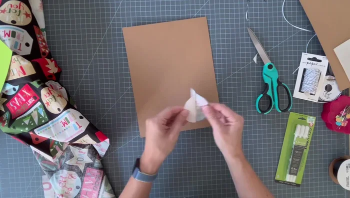 Iron fabric onto paper: Remove the paper backing from the fusible web and carefully iron the fabric onto your chosen paper.