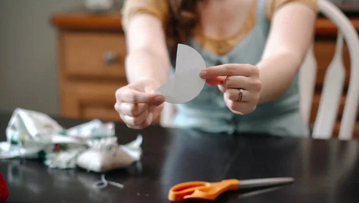 Sew T-pee: Fold fabric right sides together, sew along the edge with a quarter-inch seam allowance. Turn the cone with towel fabric right side out, stack cones, pin, and sew circular edges (leaving an inch unsewn). Flip right side out and finish sewing with a whip stitch or invisible stitch.