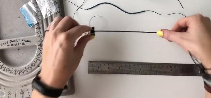 Center the beads on each strand by pulling the ends of the twine to adjust bead placement.