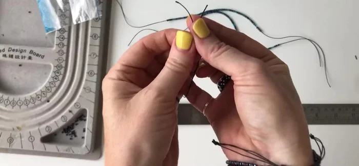 Center the beads on each strand by pulling the ends of the twine to adjust bead placement.