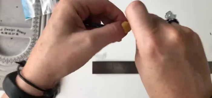 Tie a knot at the loose ends of the threads to create a secure finish.