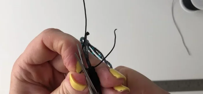 Trim the excess sliding knot threads and seal with a lighter.