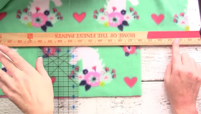 Cut 1-inch wide strips, 5 inches deep, along the entire edge of the blanket.