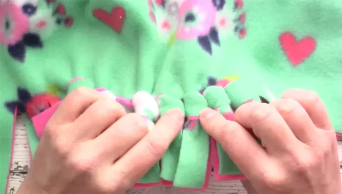 Repeat step 6 until all fringe pieces are tied.