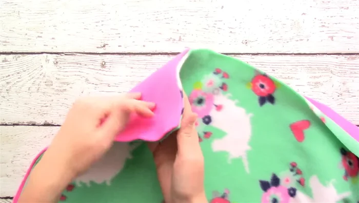 Measure 5 inches up from each corner and cut a 5x5 inch square from each corner.