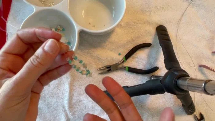 Optional: Add accent beads. At certain points, you can add larger beads or charms to create visual interest.