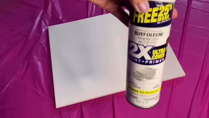 Spray paint the top half of the canvas white and the bottom half black. Let it dry.