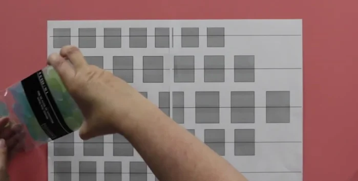 Arrange sea glass pieces on the template according to your desired color scheme (e.g., ombre).