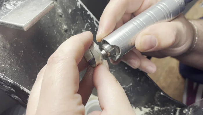 Sizing and fitting: Use a ring stretcher to adjust the gold ring to the desired size, ensuring a pressure fit onto the sterling silver band.