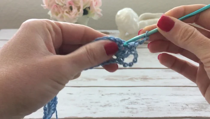 Row 3: Chain 3, turn. Skip the first double crochet of the shell. Double crochet in the next double crochet, chain 1, double crochet in the next double crochet. Repeat to create 7 double crochets in total. Skip the last double crochet. Repeat across.
