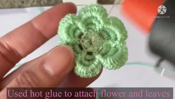 Attach leaves to the flower center using hot glue (optional).