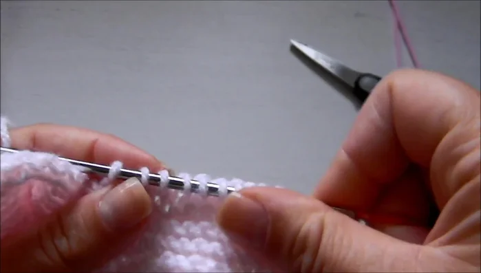 Cut yarn. Pick up 10 stitches on the right side of the heel flap, working under the Vs.