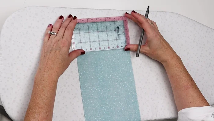 Place fabrics right sides together. Mark 2 inches down from the top edge and ½ inch in from the side edges.