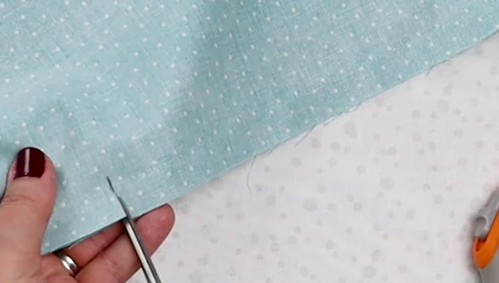 Cut along the marked lines on either side up to the 2-inch mark, being careful not to cut the stitching. Use pinking shears to finish the raw edges.