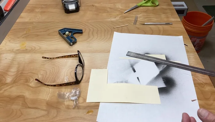 Drill a hole in the center of the plywood clock face for the clock movement shaft. Use a drill press and protect the paper face.