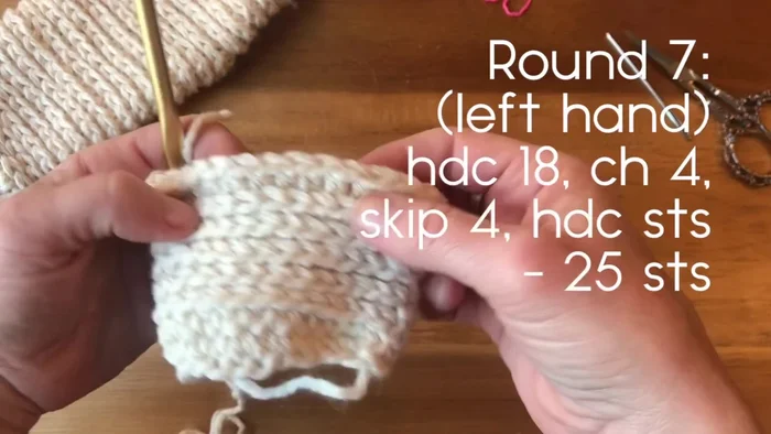 Round 7 (Thumb Hole): Work 18 half double crochets. Chain 4, skip 4 stitches, and work 3 half double crochets on the other side. (Adjust chain and skipped stitches as needed for your hand size.)