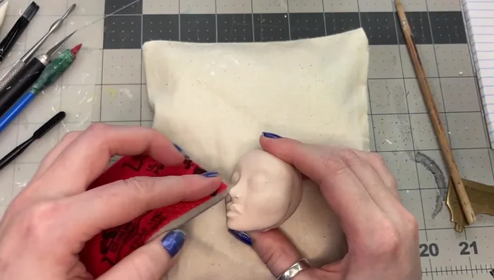 Sand the baked head using a sanding sponge to refine details and remove lumps.