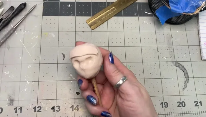 Add small amounts of clay to the forehead, chin, and jaw areas, blending well to prevent cracking.