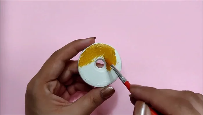 Decorate the donut shapes. (Example: paint beige, add 3D frosting, and chocolate sprinkles.)