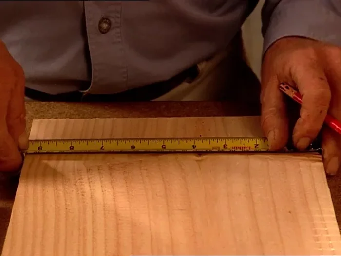 Drill a 15mm hole using a spade bit, ensuring the drill is square to the workpiece.