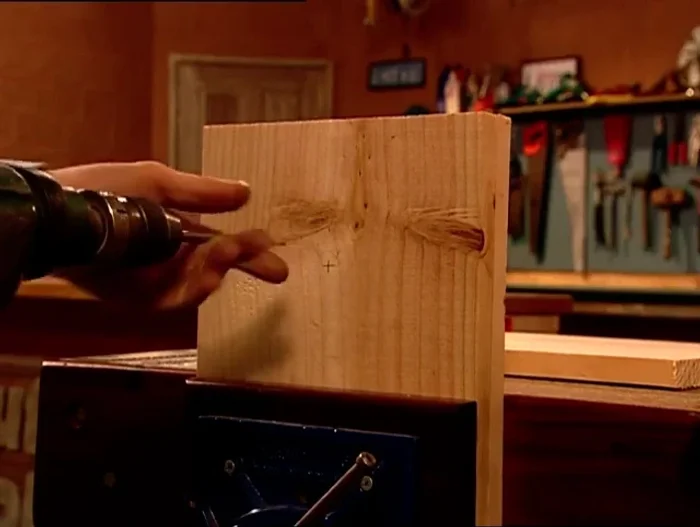 Drill a 15mm hole using a spade bit, ensuring the drill is square to the workpiece.