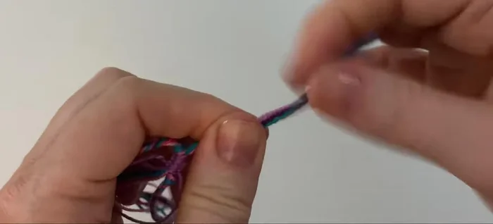 Tie a simple overhand knot at the end of each bunch of threads and trim the excess.