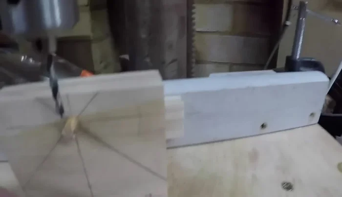 Drill spoke holes using the jig, ensuring alignment with the axle hub. Keep the jig attached to a fence for stability. Discard any pieces where the drill bit follows the grain.