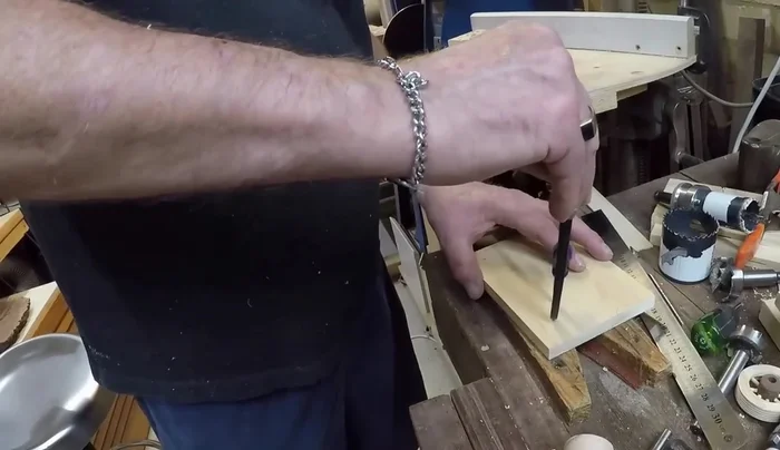 Use a 16 mil forstner bit to drill a hole about two-thirds of the way through the jig. Ensure the center circle is concentric with the outer circle.