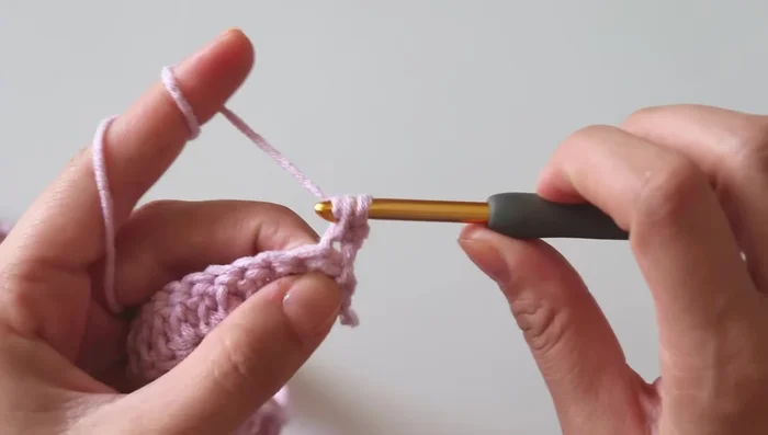 Row 2 (Bubble Stitch): *2 single crochet, yarn over, insert hook into the next stitch, yarn over, pull through 2 loops. Make 1 more single crochet in the same stitch. Yarn over, insert hook into the same stitch, yarn over, pull through 2 loops, leaving loops on hook. Repeat twice more (for a total of 5 loops on hook). Yarn over, pull through all loops on hook. This completes 1 bubble.* Single crochet in the next stitch. Repeat from * to * across. Chain 1 and turn.