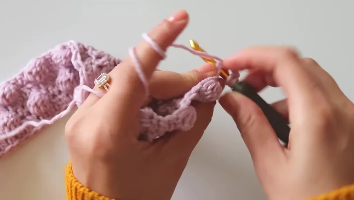 Continue alternating between Rows 2 and the finishing row (double crochet) to complete the blanket.