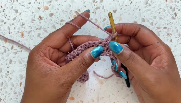 Row 3: Chain 1, turn. Double crochet in each of the next two stitches. Then, repeat: front post double crochet 2, double crochet 1 across the row. End with a double crochet in the last stitch.