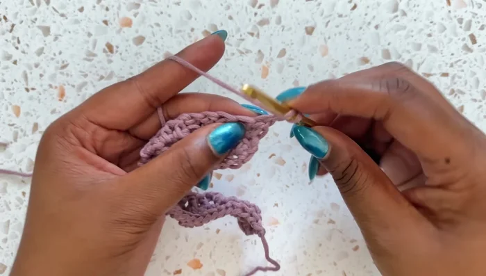 Row 3: Chain 1, turn. Double crochet in each of the next two stitches. Then, repeat: front post double crochet 2, double crochet 1 across the row. End with a double crochet in the last stitch.
