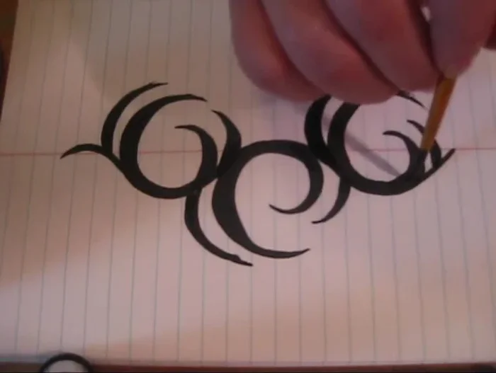 Thicken the original lines of your design by placing the brush in the thicker part of the swoop and pulling outwards.