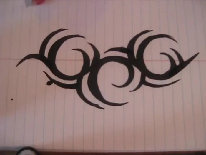 Add ‘legs’ to your design by following the curve of the existing shapes with your brush and connecting them smoothly to the thicker areas. Experiment with extending legs in different directions for varied effects.