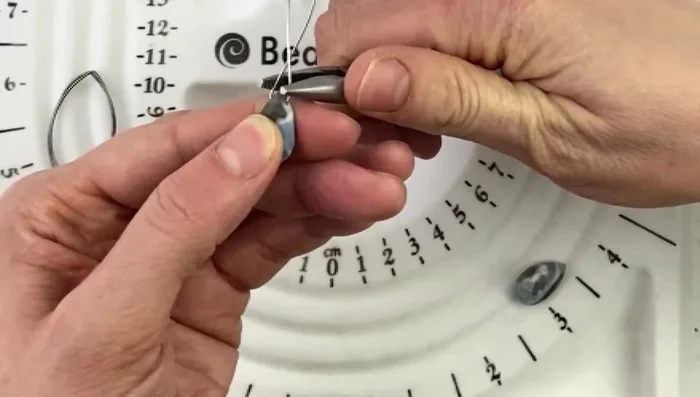 Pinch the two wire ends together using long nose pliers to create a straight, even base.