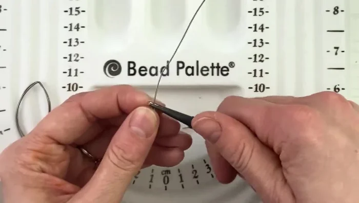 Use round nose pliers to bend the end of the wire at a 90-degree angle.
