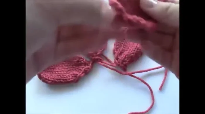 Repeat steps 2-10 to create three more petals. Sew the petals together at the base using green yarn from the bud.