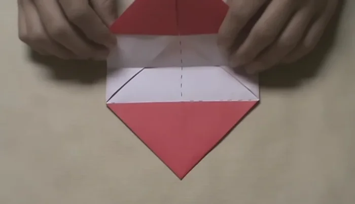 Pull up the top layer to reveal the colored triangle pocket underneath. Insert the top layer into the pocket and flatten.