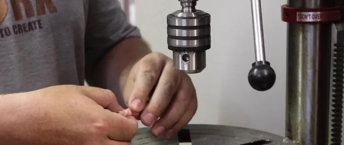 Wrap a rag around the top of the pendant to protect it from damage during the sanding process.