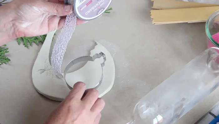 Roll the bottle over the ribbon to imprint it.