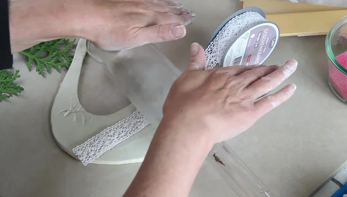 Roll the bottle over the ribbon to imprint it.