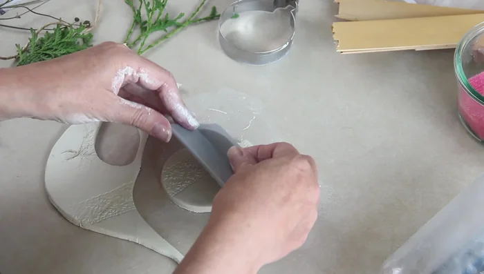Make a hole for hanging using a metal straw.
