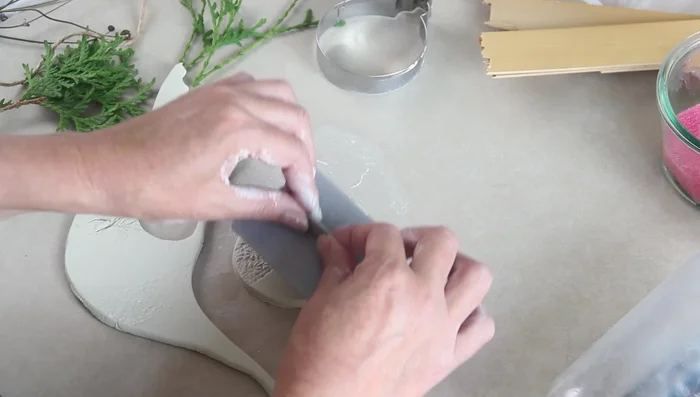 Make a hole for hanging using a metal straw.