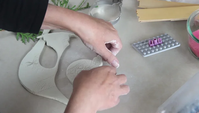 Make a hole for hanging using a metal straw.