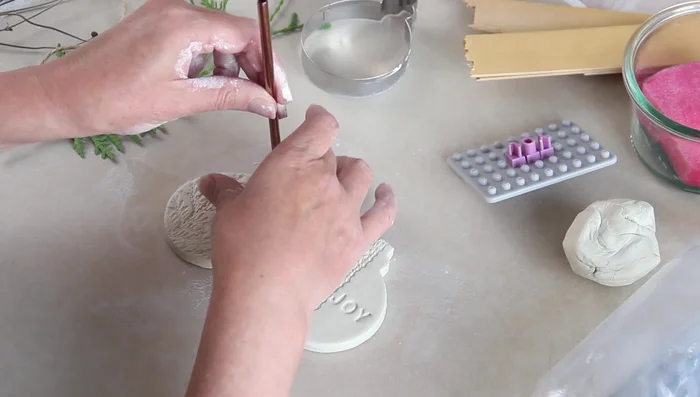 Make a hole for hanging using a metal straw.