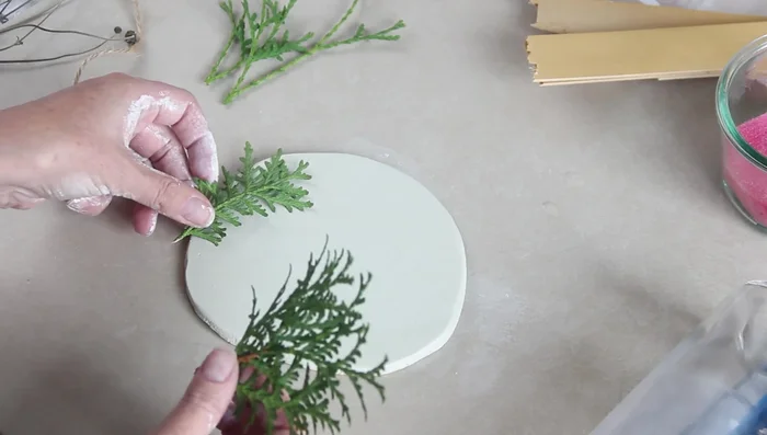 Gently lift the branches to reveal the imprint.