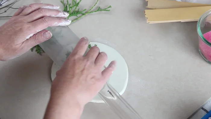 Gently lift the branches to reveal the imprint.